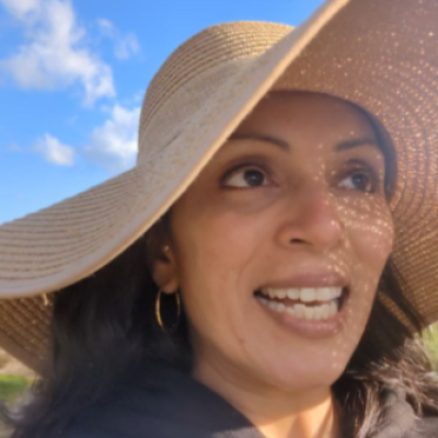 Sanjukta talking and wearing a hat