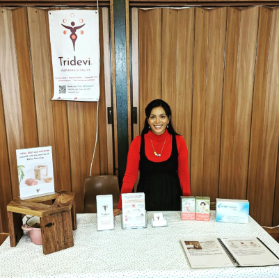 Sanjukta at her stall with steaming seat brochures and banner